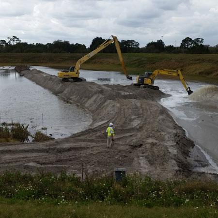 dredging boat in water in canal